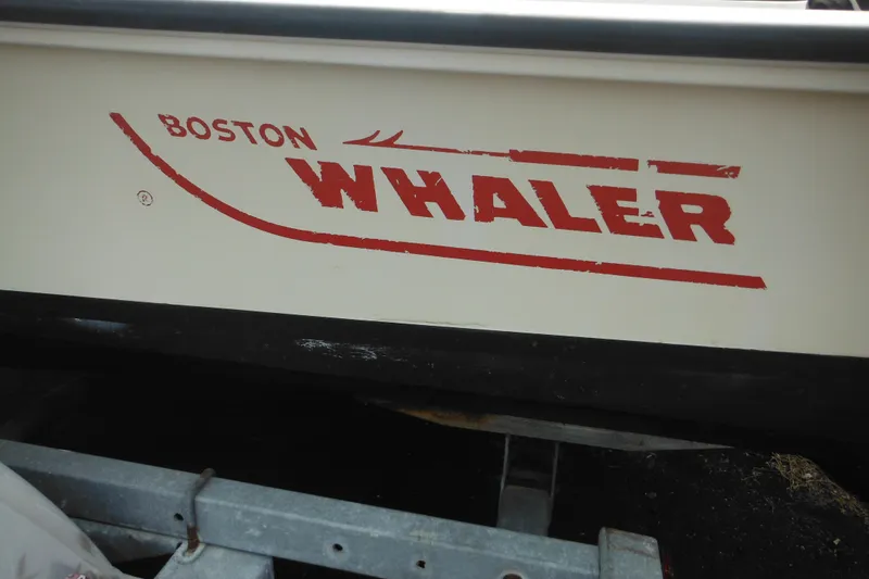 Slide: The Image of 1988 Boston Whaler 17 Super Sport boat logo on hull, red lettering. - 39