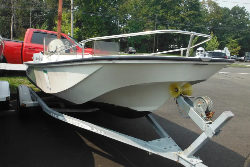 Slide: The Image of 1988 Boston Whaler 17 Super Sport boat on trailer, parked outdoors. - 4
