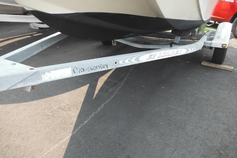 Slide: The Image of 1988 Boston Whaler 17 Super Sport on EZ Loader trailer, parked on asphalt. - 5