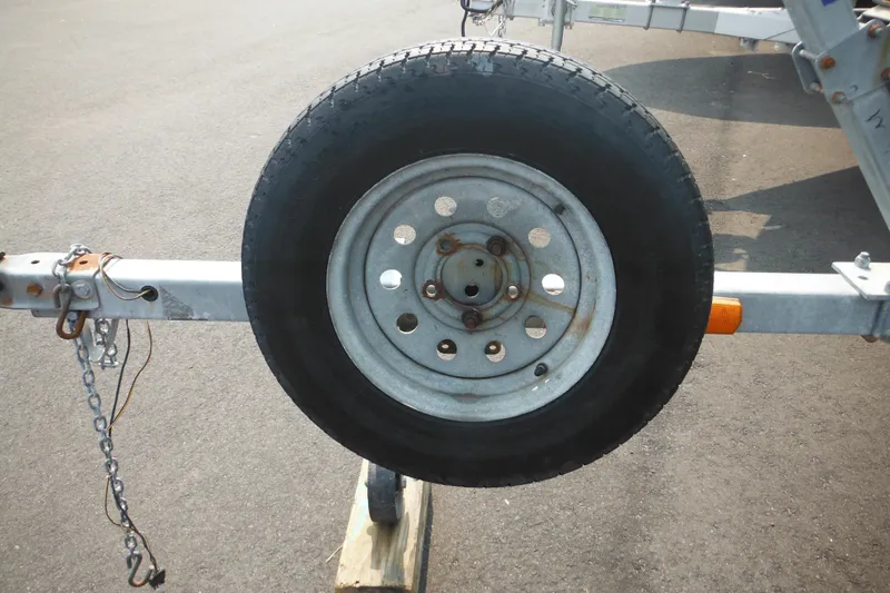 Slide: The Image of Trailer wheel for 1988 Boston Whaler 17 Super Sport on asphalt surface. - 6