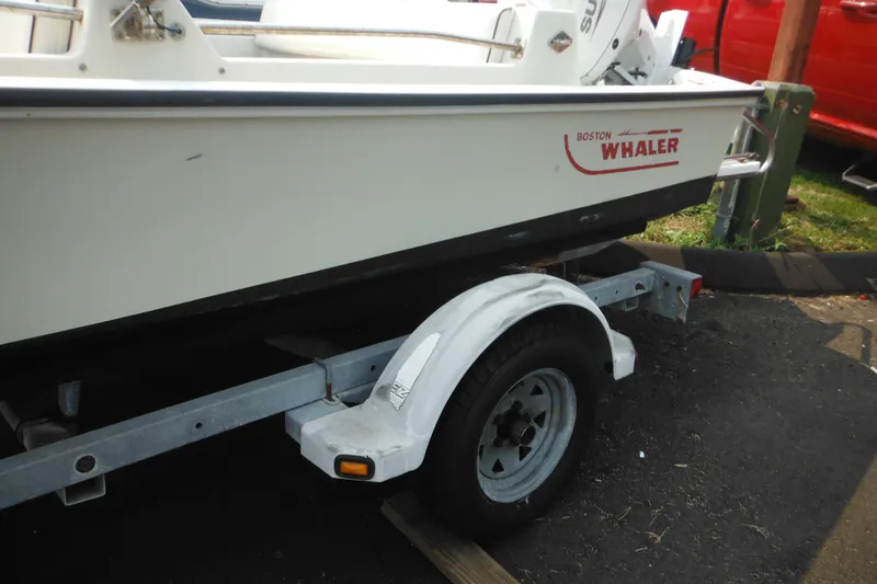 Slide: The Image of 1988 Boston Whaler 17 Super Sport boat on trailer, side view. - 7