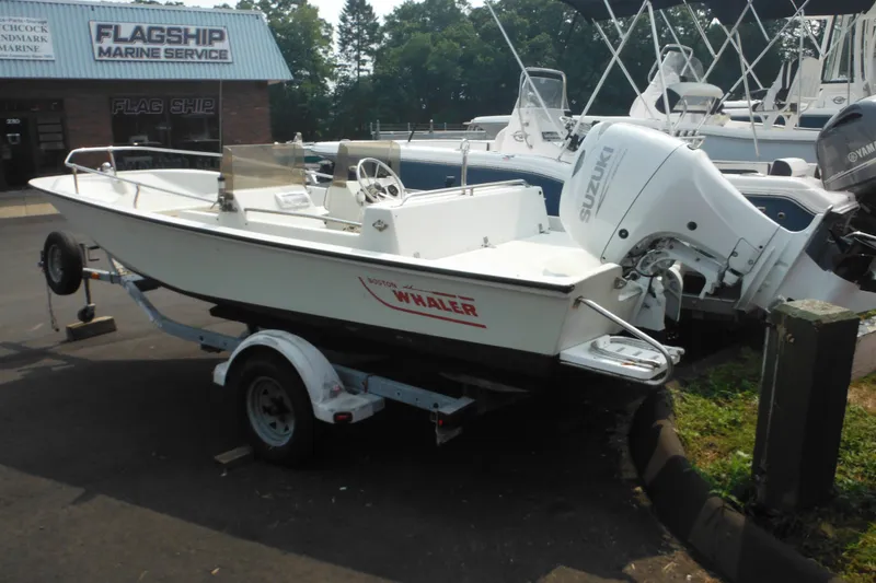 Slide: The Image of 1988 Boston Whaler 17 Super Sport boat on trailer at marine service center. - 8