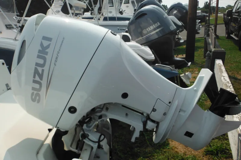 Slide: The Image of 1988 Boston Whaler 17 Super Sport with Suzuki outboard motor, parked alongside other boats. - 9