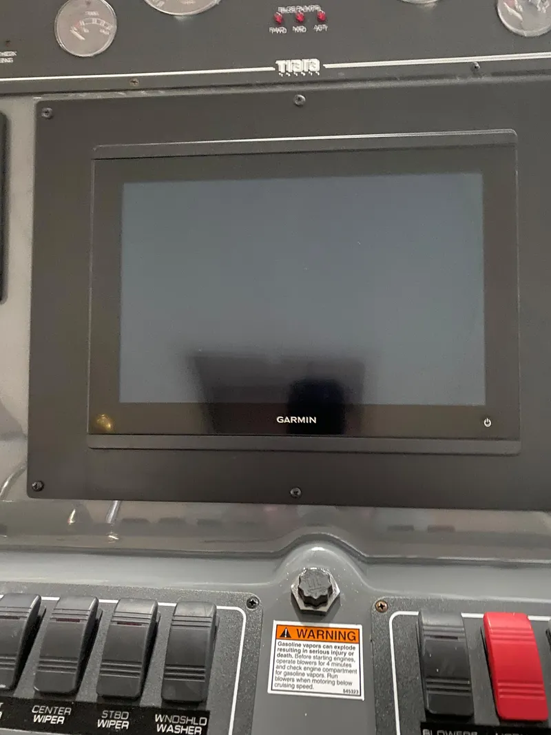 Slide: The Image of 2005 Tiara Yachts 3600 Sovran dashboard with Garmin display and control switches. - 11