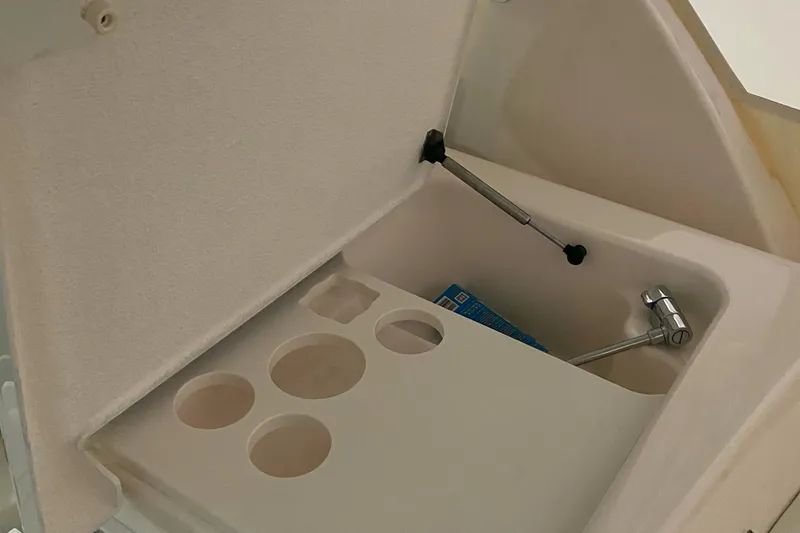 Slide: The Image of 2005 Tiara Yachts 3600 Sovran storage compartment with cup holders and hydraulic lift. - 19