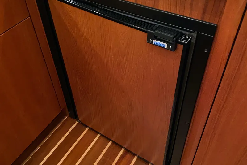 Slide: The Image of Wood-paneled refrigerator in 2005 Tiara Yachts 3600 Sovran, featuring elegant interior design. - 27