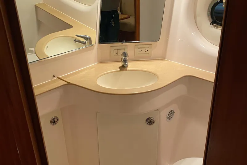 Slide: The Image of 2005 Tiara Yachts 3600 Sovran bathroom with sink, mirror, and porthole window. - 32