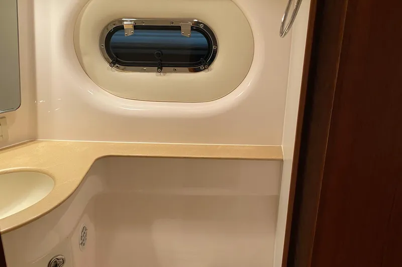 Slide: The Image of 2005 Tiara Yachts 3600 Sovran bathroom with porthole and sink. - 33
