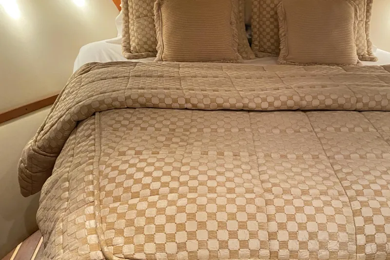 Slide: The Image of Luxurious cabin bed in 2005 Tiara Yachts 3600 Sovran, featuring elegant beige bedding. - 39