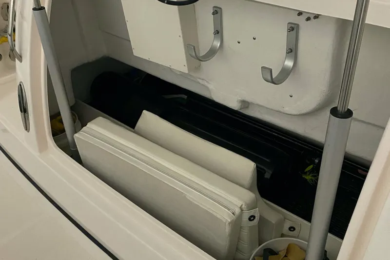Slide: The Image of Storage compartment in a 2005 Tiara Yachts 3600 Sovran boat, featuring hooks and cushions. - 42