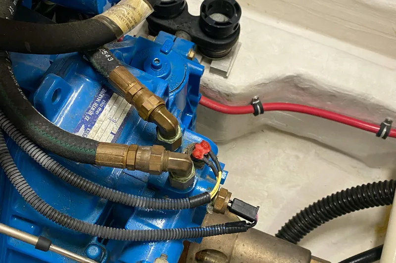 Slide: The Image of Engine components of a 2005 Tiara Yachts 3600 Sovran, featuring blue and brass fittings. - 45