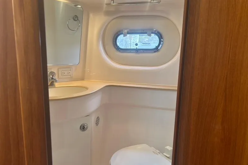 Slide: The Image of 2005 Tiara Yachts 3600 Sovran bathroom with sink, mirror, and porthole window. - 52