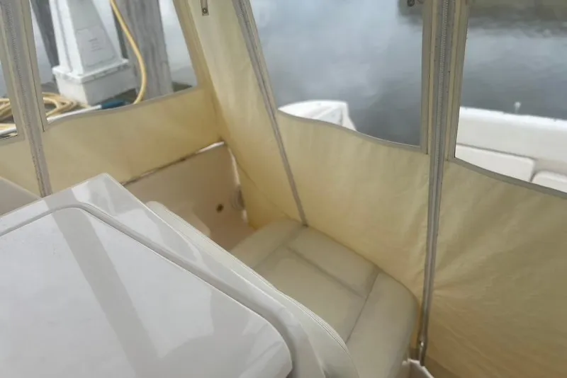 Slide: The Image of 2005 Tiara Yachts 3600 Sovran interior with beige seating and clear enclosure. - 58