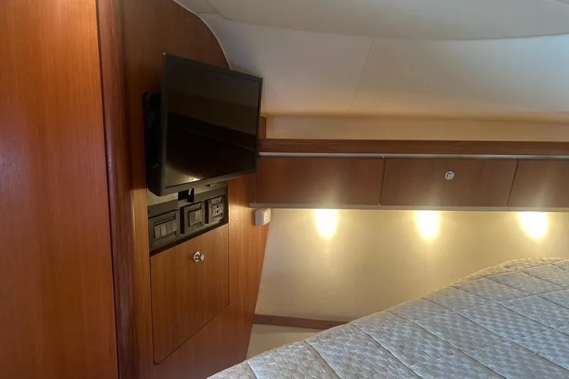 Slide: The Image of 2005 Tiara Yachts 3600 Sovran interior with TV, wood paneling, and ambient lighting. - 61