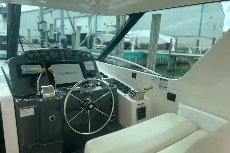 Slide: The Image of 2005 Tiara Yachts 3600 Sovran helm with Garmin navigation system and steering wheel. - 67