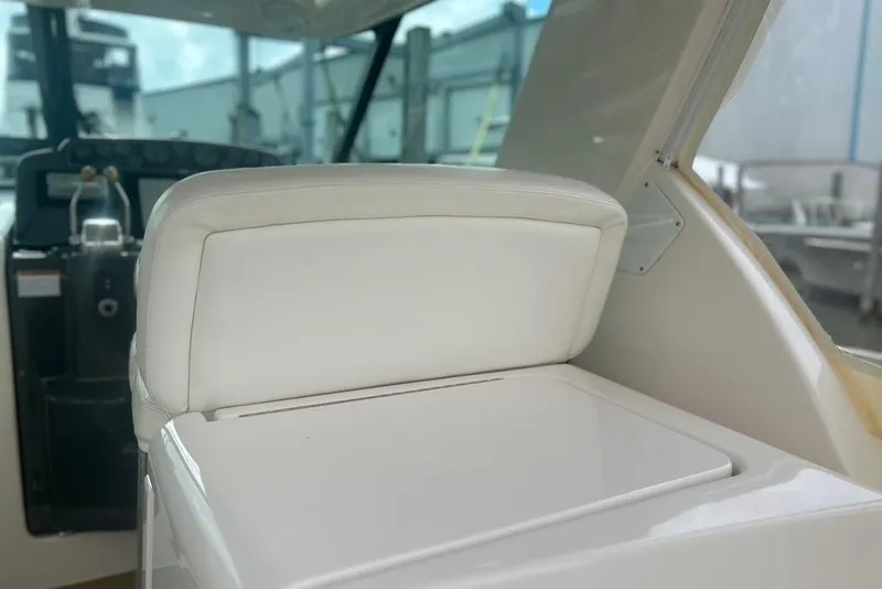 Slide: The Image of 2005 Tiara Yachts 3600 Sovran helm seat with white upholstery and dashboard view. - 68