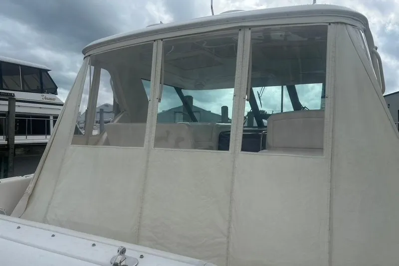 Slide: The Image of 2005 Tiara Yachts 3600 Sovran with enclosed cockpit, docked at marina. - 70