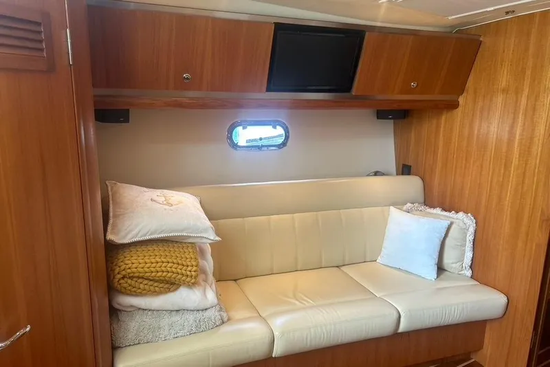 Slide: The Image of 2005 Tiara Yachts 3600 Sovran interior with beige leather sofa and wooden cabinetry. - 71