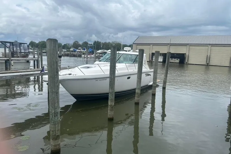 Slide: The Image of 2005 Tiara Yachts 3600 Sovran docked at a marina under cloudy skies. - 79
