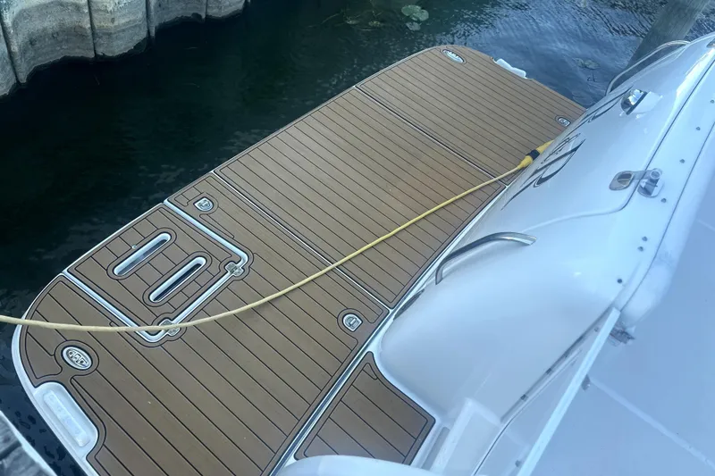 Slide: The Image of 2005 Tiara Yachts 3600 Sovran swim platform with teak decking by the water. - 81