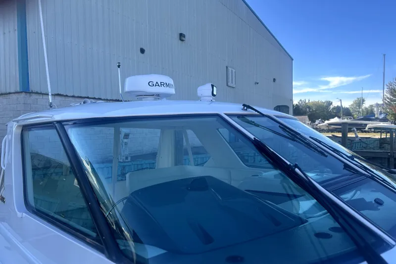 Slide: The Image of 2005 Tiara Yachts 3600 Sovran with Garmin radar, docked near a warehouse. - 83