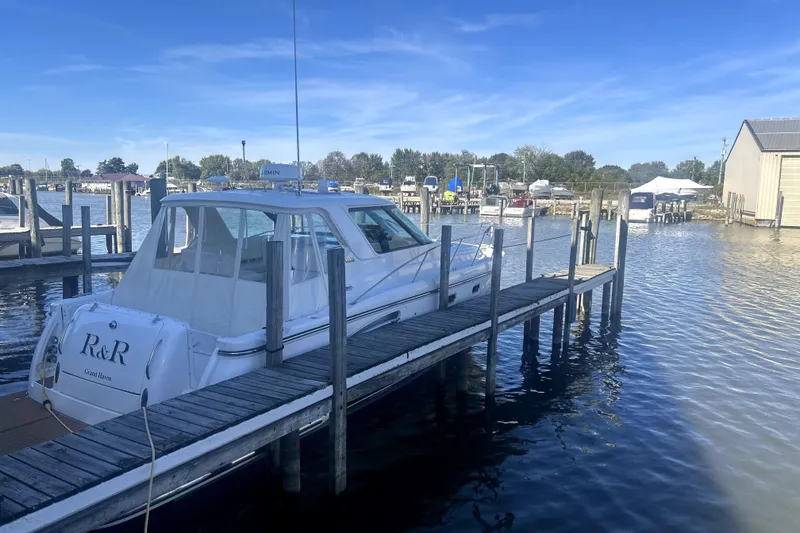 Slide: The Image of 2005 Tiara Yachts 3600 Sovran docked at marina under clear blue sky. - 85