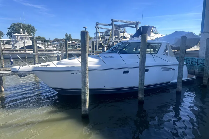 Slide: The Image of 2005 Tiara Yachts 3600 Sovran docked at marina under clear blue sky. - 88