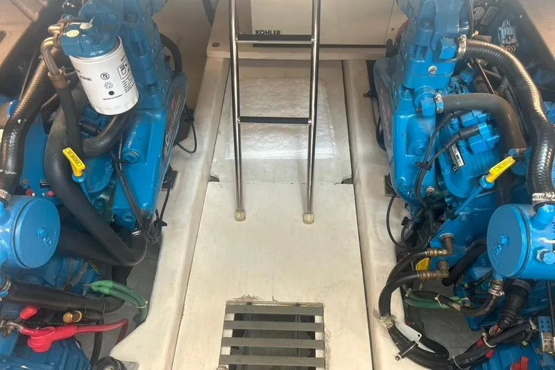 Slide: The Image of Engine room of a 2005 Tiara Yachts 3600 Sovran, featuring dual blue engines. - 91
