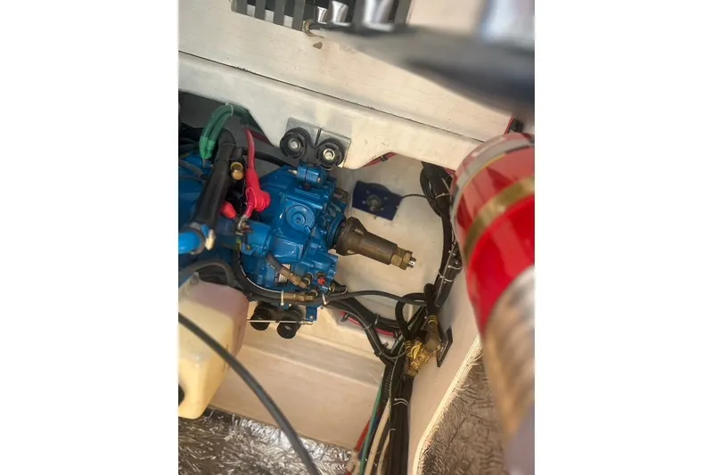 Slide: The Image of Engine compartment of a 2005 Tiara Yachts 3600 Sovran, featuring blue machinery and wiring. - 93