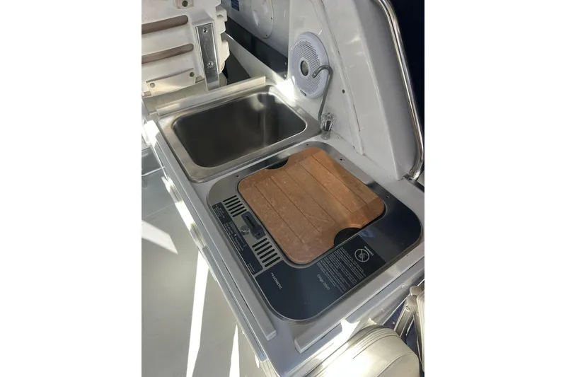 Slide: The Image of 2004 Glacier Bay 2680 Coastal Runner boat kitchen with sink and stove. - 24