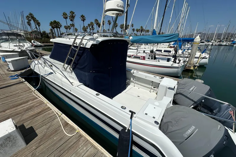 Slide: The Image of 2004 Glacier Bay 2680 Coastal Runner docked at marina with Yamaha engines. - 5