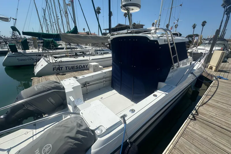 Slide: The Image of 2004 Glacier Bay 2680 Coastal Runner docked at marina with Yamaha engines. - 9