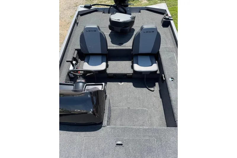 Slide: The Image of 2026 Lowe Legacy boat interior with dual seats and steering console. - 3