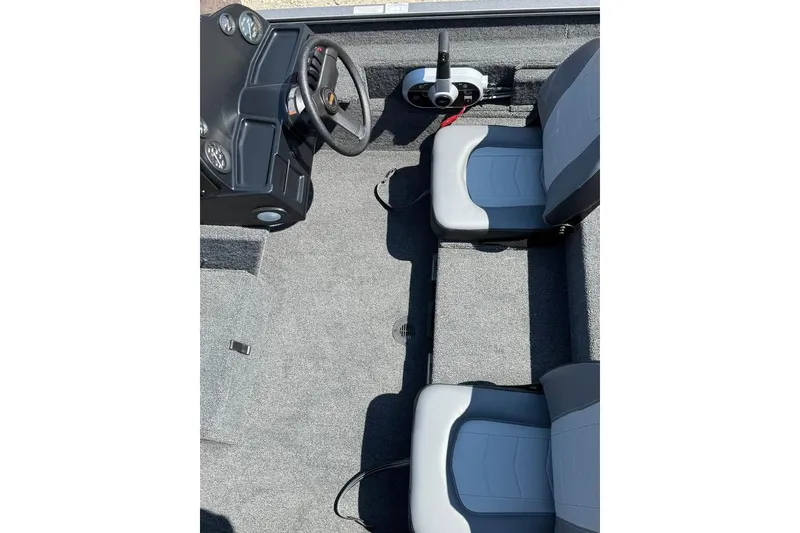 Slide: The Image of 2026 Lowe Legacy boat interior with steering wheel and dual seats. - 5