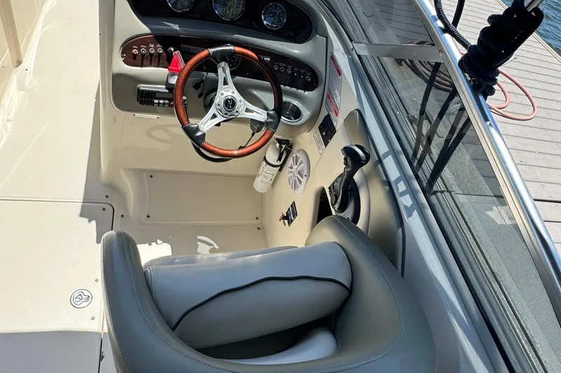 Slide: The Image of 2005 Sea Ray 270 SLX boat on trailer, parked outdoors under clear blue sky. - 11