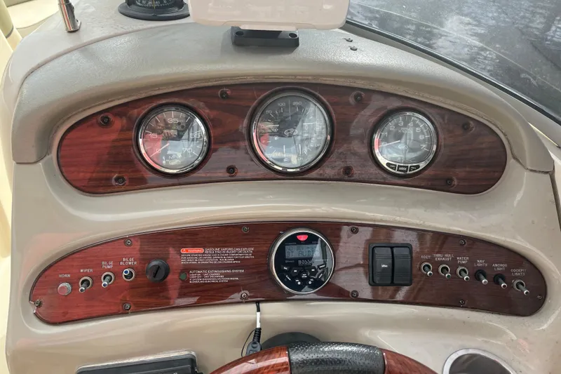 Slide: The Image of 2005 Sea Ray 270 SLX boat on trailer, parked in a suburban neighborhood. - 12