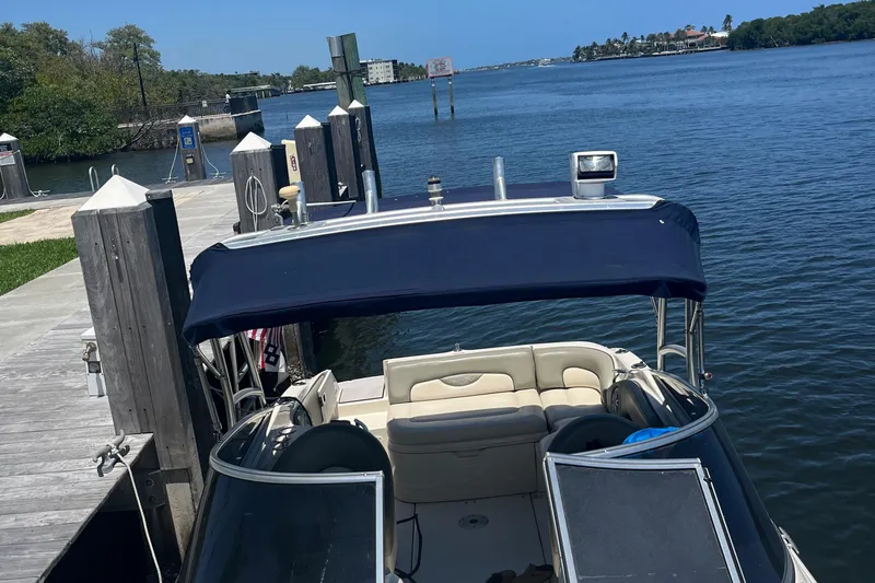 Slide: The Image of 2005 Sea Ray 270 SLX boat on trailer, parked on a sunny residential street. - 15