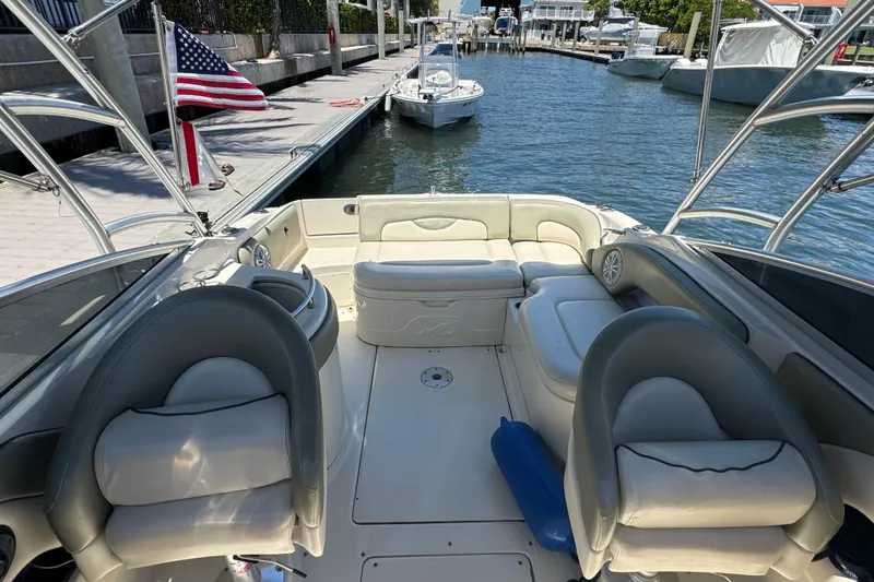 Slide: The Image of 2005 Sea Ray 270 SLX boat on trailer, parked in a sunny residential area. - 8