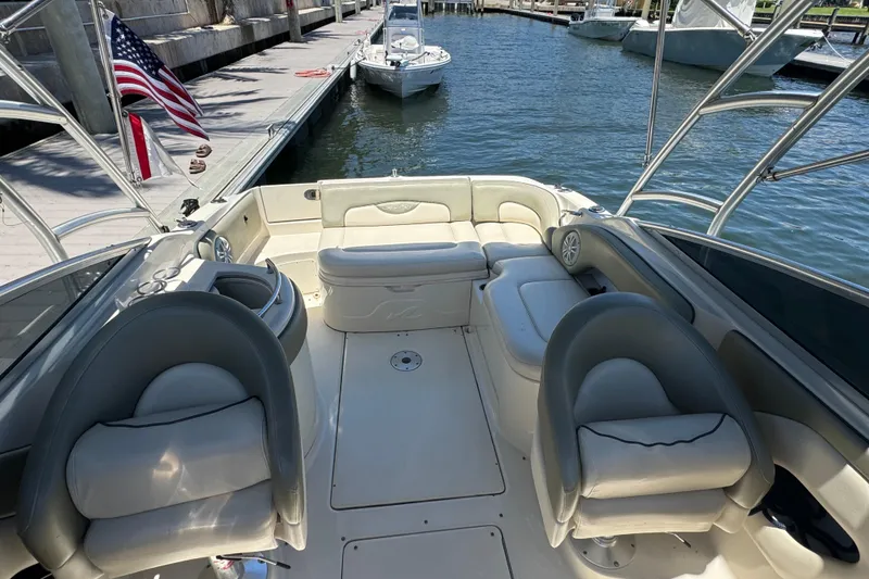 Slide: The Image of 2005 Sea Ray 270 SLX boat on trailer, parked in a residential area with palm trees. - 9