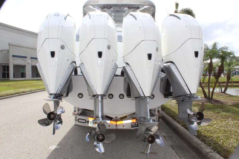 Slide: The Image of 2020 Mystic Powerboats M4200 with four powerful outboard engines, rear view. - 11