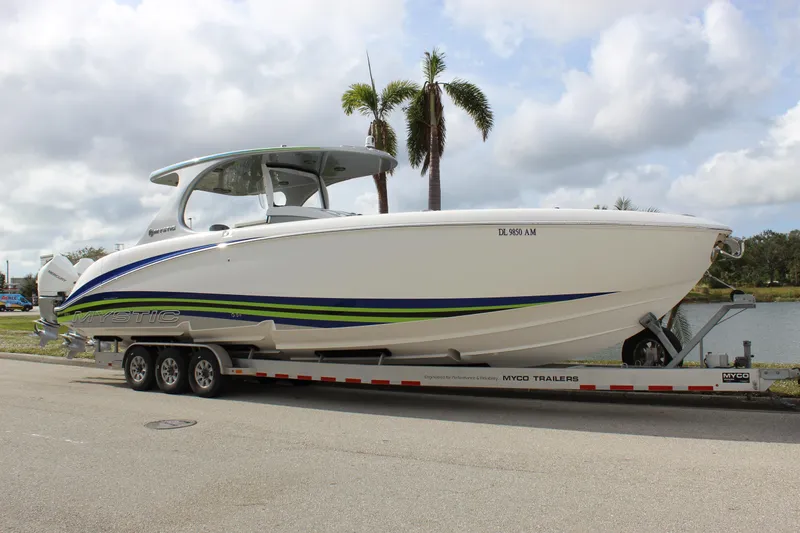 Slide: The Image of 2020 Mystic Powerboats M4200 on trailer, sleek design with blue and green accents. - 14