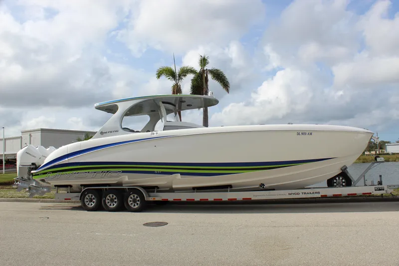 Slide: The Image of 2020 Mystic Powerboats M4200 on trailer, sleek design with blue and green accents. - 15