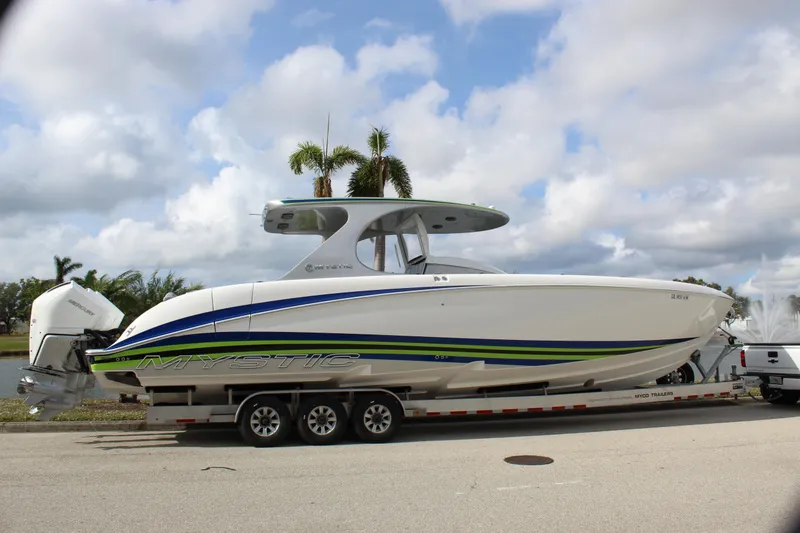 Slide: The Image of 2020 Mystic Powerboats M4200 on trailer, sleek design with vibrant accents. - 17