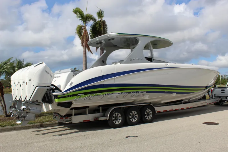Slide: The Image of 2020 Mystic Powerboats M4200 on trailer, sleek design with triple engines. - 19