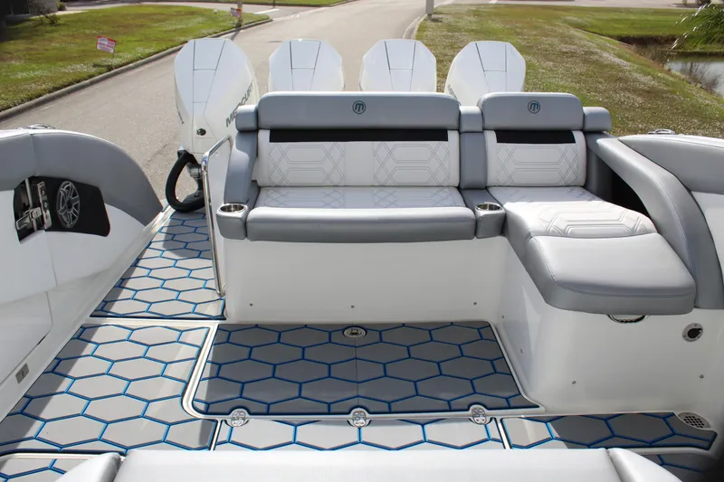 Slide: The Image of 2020 Mystic Powerboats M4200 interior with stylish seating and hexagonal floor design. - 24