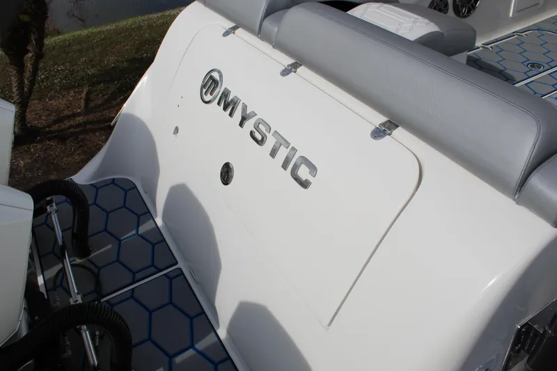 Slide: The Image of 2020 Mystic Powerboats M4200, white seating area with logo, blue hexagonal flooring. - 25