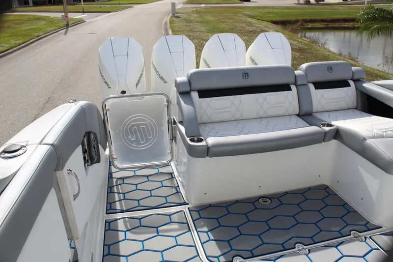 Slide: The Image of 2020 Mystic Powerboats M4200 interior with stylish seating and powerful outboard engines. - 27