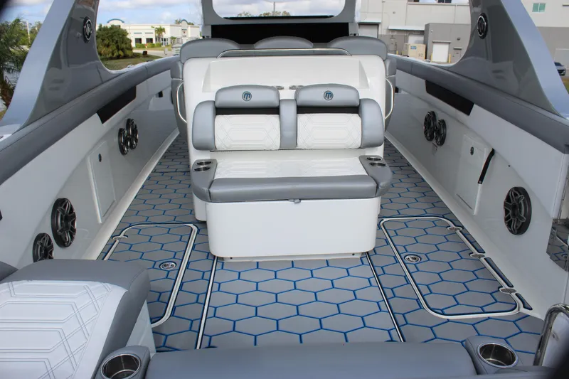 Slide: The Image of 2020 Mystic Powerboats M4200 interior with modern seating and hexagonal floor design. - 30