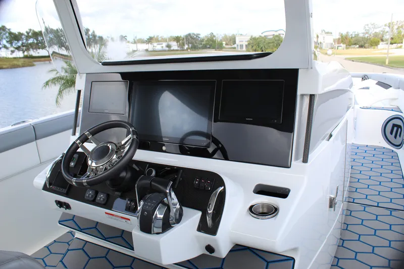Slide: The Image of 2020 Mystic Powerboats M4200 helm with modern controls and sleek design. - 37