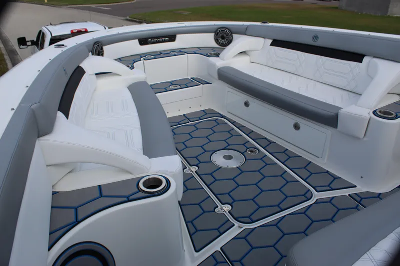Slide: The Image of 2020 Mystic Powerboats M4200 interior with hexagonal flooring and cushioned seating. - 41